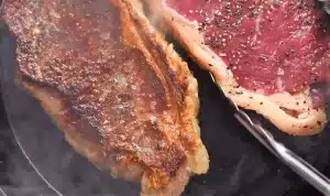 Place the pork chops in the pan once the butter has melted and cook them until they are cooked to your taste for Texas Roadhouse Pork Chop Peppercorn Sauce Recipe.