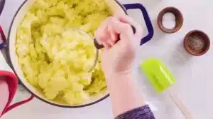 To the mashed potatoes, add salt and freshly ground black pepper for Texas Roadhouse Mashed Potatoes Recipe.