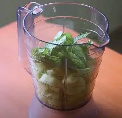 gently crush 10-12 fresh mint leaves and add them to the shaker as well.