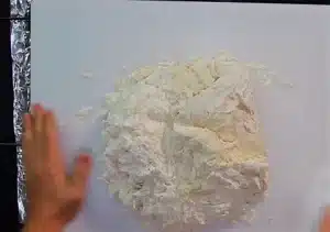 The dough should be taken off the table and kneaded very well with the help of hands until it becomes smooth and sticky