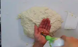 rub the dough very well with some olive oil in your hands and make it into a ball