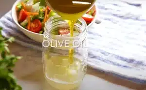 mixing vinegar, lemon juice and olive oil for Texas Roadhouse Italian Salad Dressing Recipe.