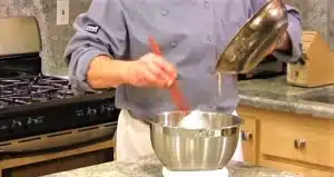 Pour the olive oil garlic butter mixture over the bread cubes for Texas Roadhouse Crouton Recipe