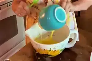 Beat two eggs in a mixing dish until fully mixed. Add a cup of mayonnaise to the beaten eggs and whisk until smooth for Brenda Gantt Squash Casserole Recipe